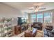 Cozy living room with a ceiling fan, tile floor and built-in electric fireplace, perfect for relaxing at 2787 Donatello Manor Pl, Henderson, NV 89044