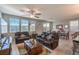 Open living space with tile floors, ceiling fan and recessed lighting with large windows at 2787 Donatello Manor Pl, Henderson, NV 89044