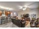 Open-concept living room featuring tile floors, ceiling fan and comfortable leather seating at 2787 Donatello Manor Pl, Henderson, NV 89044