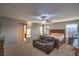 Spacious primary bedroom boasts a ceiling fan, plush carpet, and natural light from the windows at 2787 Donatello Manor Pl, Henderson, NV 89044