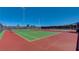Bright, well-maintained tennis court with red and green surfaces, promising an active lifestyle for residents at 2787 Donatello Manor Pl, Henderson, NV 89044