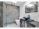 Modern bathroom featuring gray tiled walls, glass shower, and vessel sink at 2851 S Valley View Blvd # 1120, Las Vegas, NV 89102