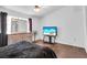 Bright bedroom with neutral walls, laminate floors, a ceiling fan, and a large window at 2851 S Valley View Blvd # 1120, Las Vegas, NV 89102