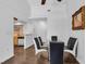 Bright dining area with dark laminate floors, modern glass table, and view of the kitchen at 2851 S Valley View Blvd # 1120, Las Vegas, NV 89102