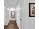 Hallway with laminate floors, white walls, and artful decorations on the walls at 2851 S Valley View Blvd # 1120, Las Vegas, NV 89102