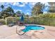 Inviting community hot tub area surrounded by a white fence and lush landscaping with a table and chairs at 2851 S Valley View Blvd # 1120, Las Vegas, NV 89102