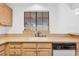 Kitchen sink features laminate countertops, light wooden cabinetry, and a window view at 2851 S Valley View Blvd # 1120, Las Vegas, NV 89102