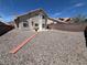 Expansive backyard featuring desert landscaping, privacy walls, and a small bench seating area at 3238 Canyon Terrace Dr, Laughlin, NV 89029
