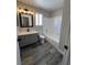 Bathroom featuring a gray vanity with a black faucet, a mirror, and a shower-tub combo at 3238 Canyon Terrace Dr, Laughlin, NV 89029