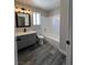 Bathroom featuring a gray vanity with a black faucet, a mirror, and a shower-tub combo at 3238 Canyon Terrace Dr, Laughlin, NV 89029