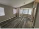 Spacious bedroom featuring light gray walls, multiple windows, and modern gray wood flooring at 3238 Canyon Terrace Dr, Laughlin, NV 89029