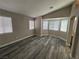 Spacious bedroom featuring light gray walls, multiple windows, and modern gray wood flooring at 3238 Canyon Terrace Dr, Laughlin, NV 89029