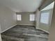 Bedroom featuring light gray walls, multiple windows, and modern gray wood flooring at 3238 Canyon Terrace Dr, Laughlin, NV 89029