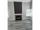 Close up of the fireplace with a stone surround and black mantle at 3238 Canyon Terrace Dr, Laughlin, NV 89029