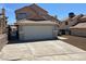 Two-story home featuring a two-car garage, landscaped front yard, and tile roof at 3238 Canyon Terrace Dr, Laughlin, NV 89029