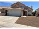 Well-kept two-story home with a two-car garage, mature landscaping, and inviting entrance at 3238 Canyon Terrace Dr, Laughlin, NV 89029