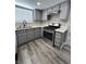 Well-equipped kitchen featuring gray cabinets, stainless steel oven, and solid surface countertops at 3238 Canyon Terrace Dr, Laughlin, NV 89029