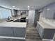 Open kitchen with solid surface counters, gray cabinets, and stainless steel appliances at 3238 Canyon Terrace Dr, Laughlin, NV 89029