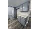 Kitchen area with gray cabinets, solid surface countertops, and modern wood flooring at 3238 Canyon Terrace Dr, Laughlin, NV 89029