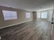 Spacious living room with multiple windows and modern gray wood flooring at 3238 Canyon Terrace Dr, Laughlin, NV 89029