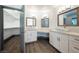 Bathroom featuring double sink vanity, wood floors, and spacious walk-in closet at 3241 E Winery Rd, Pahrump, NV 89048