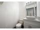 Modern half-bathroom featuring a vessel sink, stylish fixtures, and a sleek vanity with grey trim at 3241 E Winery Rd, Pahrump, NV 89048