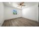 Bedroom with wood-look flooring, ceiling fan, natural light and neutral color palette at 3241 E Winery Rd, Pahrump, NV 89048