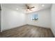 Comfortable bedroom with wood-look flooring, a ceiling fan, and natural light from the window at 3241 E Winery Rd, Pahrump, NV 89048