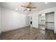 Well-lit bedroom with wood-look flooring, closet, ceiling fan, and neutral color palette at 3241 E Winery Rd, Pahrump, NV 89048
