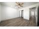 Neutral bedroom with a ceiling fan, wood-look flooring, and a closet at 3241 E Winery Rd, Pahrump, NV 89048