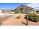 Beautiful single-story home with landscaped yard, desert landscape, and covered porch in front of the house at 3241 E Winery Rd, Pahrump, NV 89048