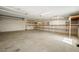 Clean three-car garage with ceiling fans, shelving, and plenty of natural light at 3241 E Winery Rd, Pahrump, NV 89048
