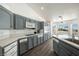 Bright kitchen with gray cabinets, stainless steel microwave, stainless steel oven, and a breakfast bar at 3241 E Winery Rd, Pahrump, NV 89048