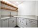 Well-lit laundry room features custom storage and quartz countertop at 3241 E Winery Rd, Pahrump, NV 89048