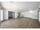 Expansive living room features light wood floors, recessed lighting, and views from french doors at 3241 E Winery Rd, Pahrump, NV 89048