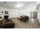 Open floor plan in living room boasts modern fireplace and wood laminate flooring at 3241 E Winery Rd, Pahrump, NV 89048