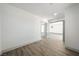 Bright, open-concept living room with grey trim, wood floors and an open doorway at 3241 E Winery Rd, Pahrump, NV 89048