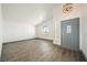 Bright living room showcasing wood flooring, neutral paint, and an arched window at 3241 E Winery Rd, Pahrump, NV 89048