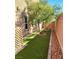 Cozy backyard with a small turf lawn, desert landscaping, and a wood lattice fence at 3617 Austell St, Las Vegas, NV 89129