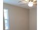 A neutral bedroom with a ceiling fan and a large window, providing comfortable living space at 3617 Austell St, Las Vegas, NV 89129