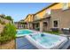Beautiful backyard with pool, hot tub, outdoor kitchen and patio, and lush landscaping at 391 Capistrano Vistas St, Las Vegas, NV 89138