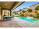 Backyard with a sparkling pool, water feature, hot tub, and lush landscaping at 391 Capistrano Vistas St, Las Vegas, NV 89138