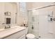 Bright bathroom with marble countertops, a glass enclosed shower, and white tile surround at 391 Capistrano Vistas St, Las Vegas, NV 89138