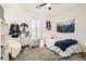 Cozy bedroom with white walls, a comfortable bed, and hockey decor accents at 391 Capistrano Vistas St, Las Vegas, NV 89138