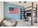 Comfortable bedroom with an American flag, loft bed, and bean bag at 391 Capistrano Vistas St, Las Vegas, NV 89138