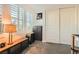 Bedroom with neutral carpet, shuttered window, and dark storage cabinet at 391 Capistrano Vistas St, Las Vegas, NV 89138