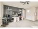 Spacious bedroom with dark accent wall, desk with dual monitors, carpeted floor, and ceiling fan at 391 Capistrano Vistas St, Las Vegas, NV 89138