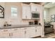 Bright kitchen with granite countertops, white subway tile backsplash, and stainless steel microwave at 391 Capistrano Vistas St, Las Vegas, NV 89138