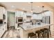 Bright kitchen boasts granite counters, stainless appliances, island with bar seating and modern pendant lights at 391 Capistrano Vistas St, Las Vegas, NV 89138