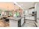 Bright kitchen features granite countertops, a center island, stainless appliances, and seamless access to dining area at 391 Capistrano Vistas St, Las Vegas, NV 89138
